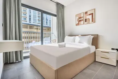 a bedroom with a large bed and a large window at STAY BY LATINEM Luxury 1BR Holiday Home CC 0302 Near Burj Khalifa in Dubai