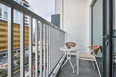 a balcony with a white table and two chairs at STAY BY LATINEM Luxury 1BR Holiday Home CC 0302 Near Burj Khalifa in Dubai