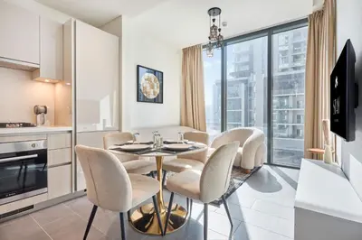 a kitchen and dining room with a table and chairs at STAY BY LATINEM Luxury 1BR Holiday Home CC 0302 Near Burj Khalifa in Dubai