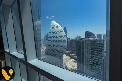 a view of a city skyline from a window at Vogue Business Bay Court Tower close to Downtown Burj Khalifa and Dubai Mall, Studio Apartment with City view in Dubai