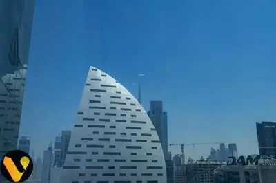 a tall white building with a yellow and black sign at Vogue Business Bay Court Tower close to Downtown Burj Khalifa and Dubai Mall, Studio Apartment with City view in Dubai