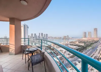 a balcony with chairs and a view of the city at StayShort - 2 Bedroom in Dubai Marina with Huge Balcony in Dubai
