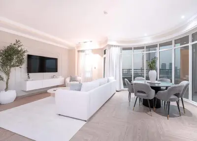 a white living room with a white couch and a table at StayShort - 2 Bedroom in Dubai Marina with Huge Balcony in Dubai