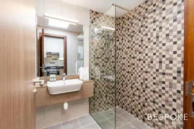 a bathroom with a sink and a shower at Bespoke Holiday Homes - Cozy Modern Studio in Samia by Azizi in Dubai