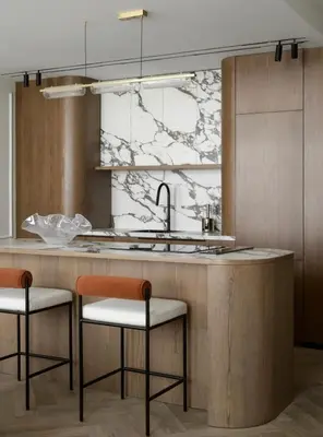 a kitchen with a sink and two bar stools at Luxurious 3br apartment Dubai mall in Dubai