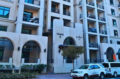 a white car parked in front of a building at Luxe 1-BR with Pool Sunset Balcony View in The Greens in Dubai