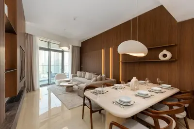 a dining room with a table and chairs and a couch at Imperial Avenue, Downtown Dubai - The Mint Stay in Dubai