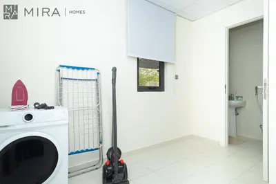 a washing machine in a bathroom with a washer at Mira Holiday Homes - Spacious 3BDR Villa Stylish & Modern Comfort in Dubai