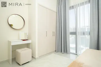 a white bedroom with a mirror and a bed at Mira Holiday Homes - Spacious 3BDR Villa Stylish & Modern Comfort in Dubai
