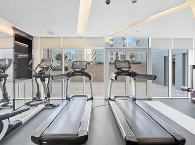 a gym with treadmills and elliptical machines at Luxury Unit High Floor Damac Majestine in Dubai