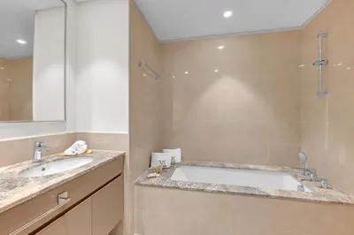 a bathroom with a large tub and a shower at 2BR Luxury Apartment in Downtown Opera in Dubai