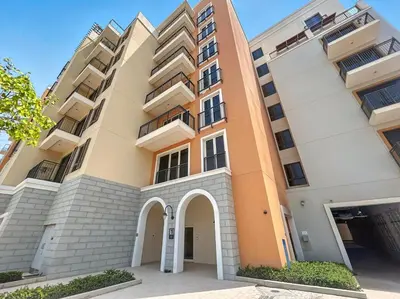 an apartment building with an orange and white at La Mer Le Pont 1 Bedroom Beachside Apartment in Dubai