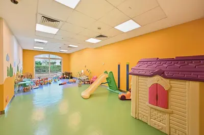 a room with a play room with a playground at Modern Luxury Upgraded 2BR Apartment The Greens in Dubai