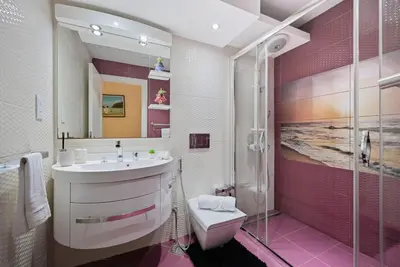 a bathroom with a sink and a shower at Modern Luxury Upgraded 2BR Apartment The Greens in Dubai