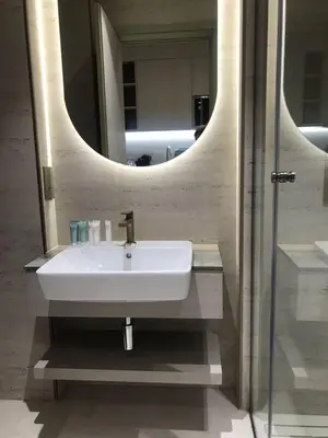 a bathroom with a sink and a mirror at Luxury Furnished Studio with Alexa Automation JVC in Dubai