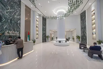 a lobby with people sitting in chairs in a building at Binghatti Phantom luxury living 5 stars amanities in Dubai