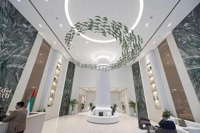 a lobby of a building with a large chandelier at Binghatti Phantom luxury living 5 stars amanities in Dubai