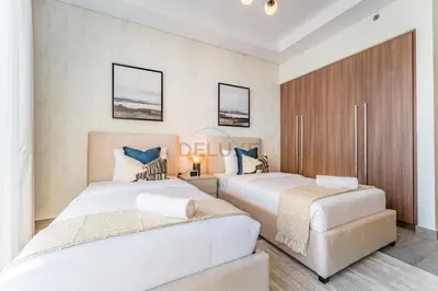 two beds in a hotel room with two beds at Walking Distance to Dubai Mall and Burj Khalifa, Easy Access to Dubai Marina, JBR Beach and Palm Jumeirah - Imperial Avenue, Downtown Dubai in Dubai