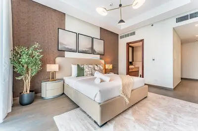 a bedroom with a large bed in a room at Walking Distance to Dubai Mall and Burj Khalifa, Easy Access to Dubai Marina, JBR Beach and Palm Jumeirah - Imperial Avenue, Downtown Dubai in Dubai