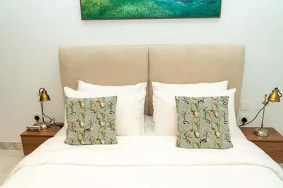 a bedroom with a bed with white sheets and pillows at 1Luxury Newbedroom nearBusiness Bay in Dubai