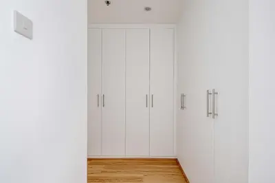 a row of white cabinets in a room at Frank Porter - Bay Square in Dubai