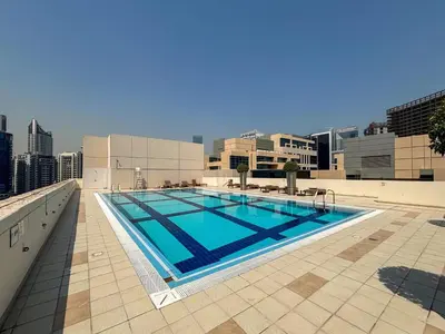 a swimming pool on the roof of a building at Frank Porter - Bay Square in Dubai
