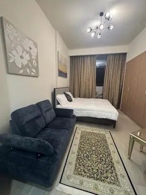 a living room with a couch and a bed at Sophisticated Studio Designer Interiors in Dubai