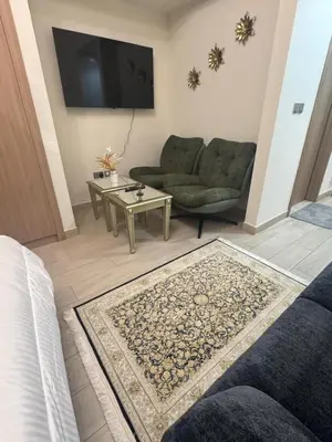a living room with a couch and a table at Sophisticated Studio Designer Interiors in Dubai