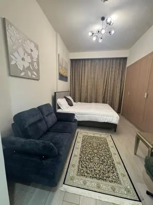 a living room with a couch and a bed at Sophisticated Studio Designer Interiors in Dubai