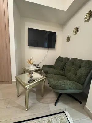 a living room with a couch and a table at Sophisticated Studio Designer Interiors in Dubai