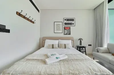 a bedroom with a bed with two towels on it at Modern Studio at Binghatti Azure In Heart of JVC in Dubai