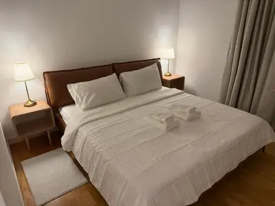 a bedroom with a bed with two towels on it at Luxury Bluewaters Residence in Dubai