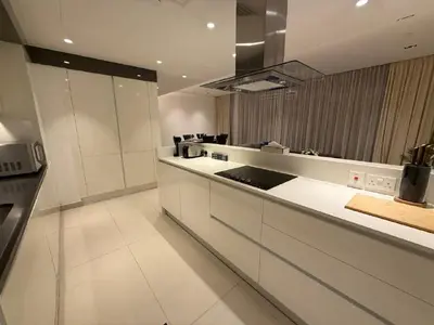 a large kitchen with white cabinets and a stove at Luxury Bluewaters Residence in Dubai