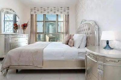 a bedroom with a large bed with a dresser and a window at Rustic Retreat in Standpoint, Heart of Downtown in Dubai
