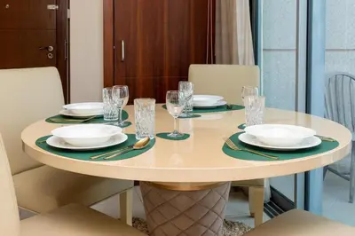 a round table with plates and glasses on it at Rustic Retreat in Standpoint, Heart of Downtown in Dubai