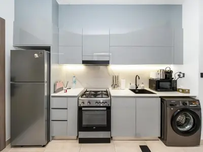 a kitchen with a stove and a refrigerator at Luxe studio Downtown Burj Khalifa Skyline view in Dubai