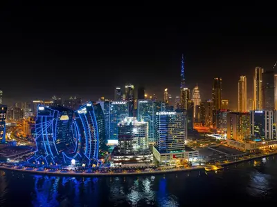 a night view of a large city with buildings at Luxe studio Downtown Burj Khalifa Skyline view in Dubai