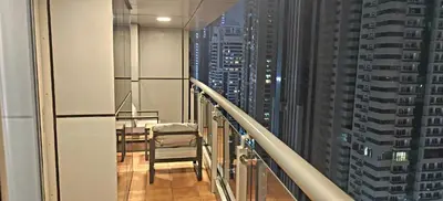 a balcony with a chair and a view of a city at Beautiful 1-BR next to Barasti Beach in Dubai