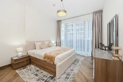a bedroom with a large bed and a large window at Skyline 1 Residence 2204 in Dubai