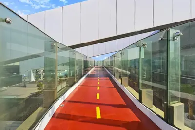 an empty corridor of a building with a red floor at Skyline 1 Residence 2204 in Dubai
