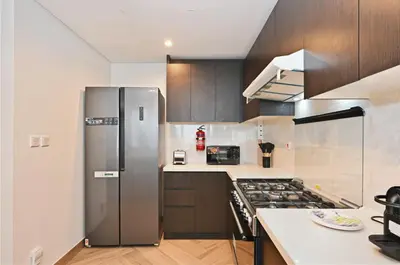 a kitchen with a stainless steel refrigerator and a stove at Skyline 1 Residence 2204 in Dubai