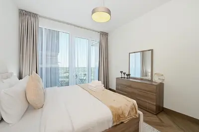 a bedroom with a large bed and a mirror at Skyline 1 Residence 2204 in Dubai