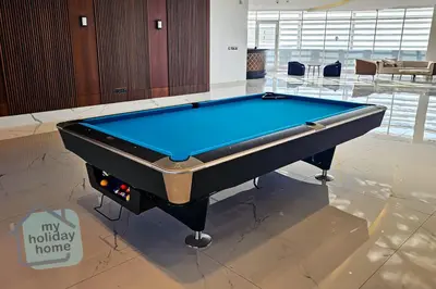 a pool table in the middle of a room at Luxury-Modern Apt with Theatre-Games-Pool-Gym in Dubai