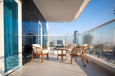 a balcony with chairs and a table on a building at Luxury-Modern Apt with Theatre-Games-Pool-Gym in Dubai
