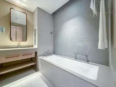 a bathroom with a tub and a sink and a mirror at 21 Vida Dubai Mall 1 bedroom in Dubai