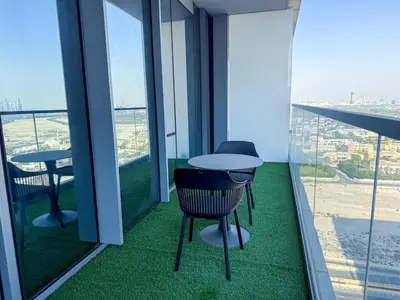 a balcony with two tables and chairs in a building at 21 Vida Dubai Mall 1 bedroom in Dubai
