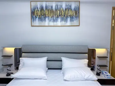 a bed with two white pillows and a painting on the wall at 21 Vida Dubai Mall 1 bedroom in Dubai