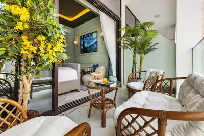 a room with a balcony with a bed and chairs at BLVD Cozy Stay with Balcony View 10mn to Downtown in Dubai