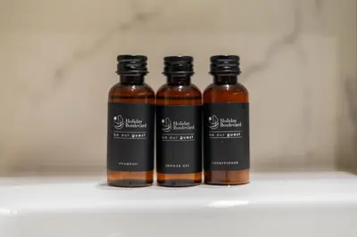 three bottles of sauce sitting on a shelf at BLVD Cozy Stay with Balcony View 10mn to Downtown in Dubai