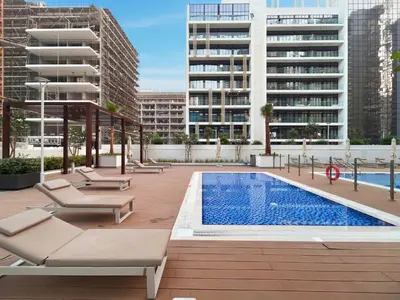 an apartment patio with a swimming pool and buildings at BLVD Cozy Stay with Balcony View 10mn to Downtown in Dubai